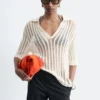 Polo-Shirt aus offenem Strick Polo-Shirt aus offenem Strick